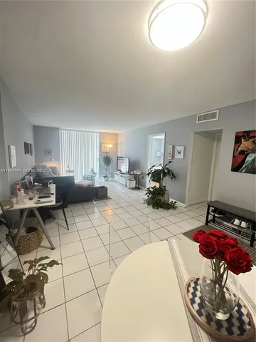 a living room with furniture a table and a mirror