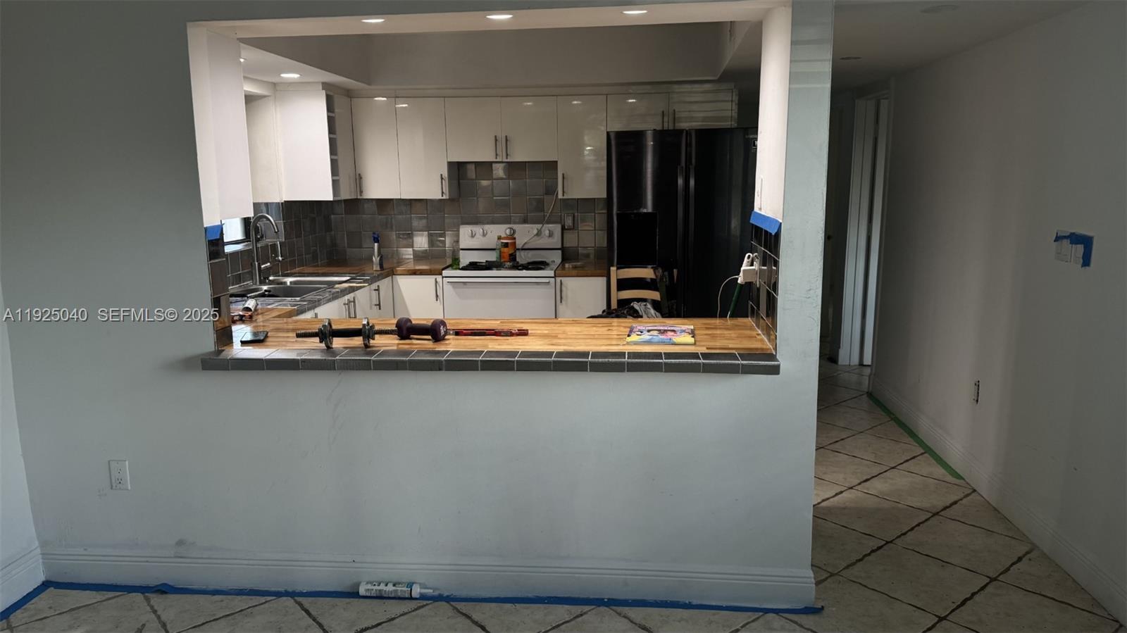 1550 Southwest 86th Court Miami, FL 33174 - Photo 3 of 6 a view of a kitchen with stainless steel appliances granite countertop a refrigerator and a counter space