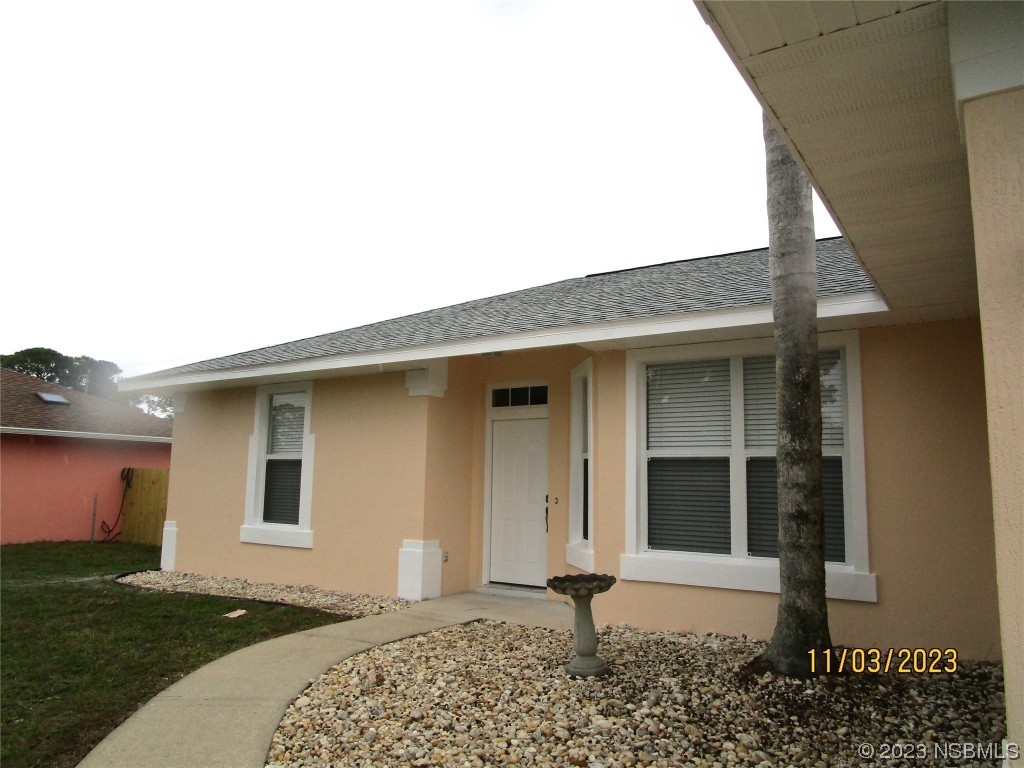 3117 Victory Palm Drive Edgewater, FL 32141 - Photo 2 of 23 a front view of a house with a yard