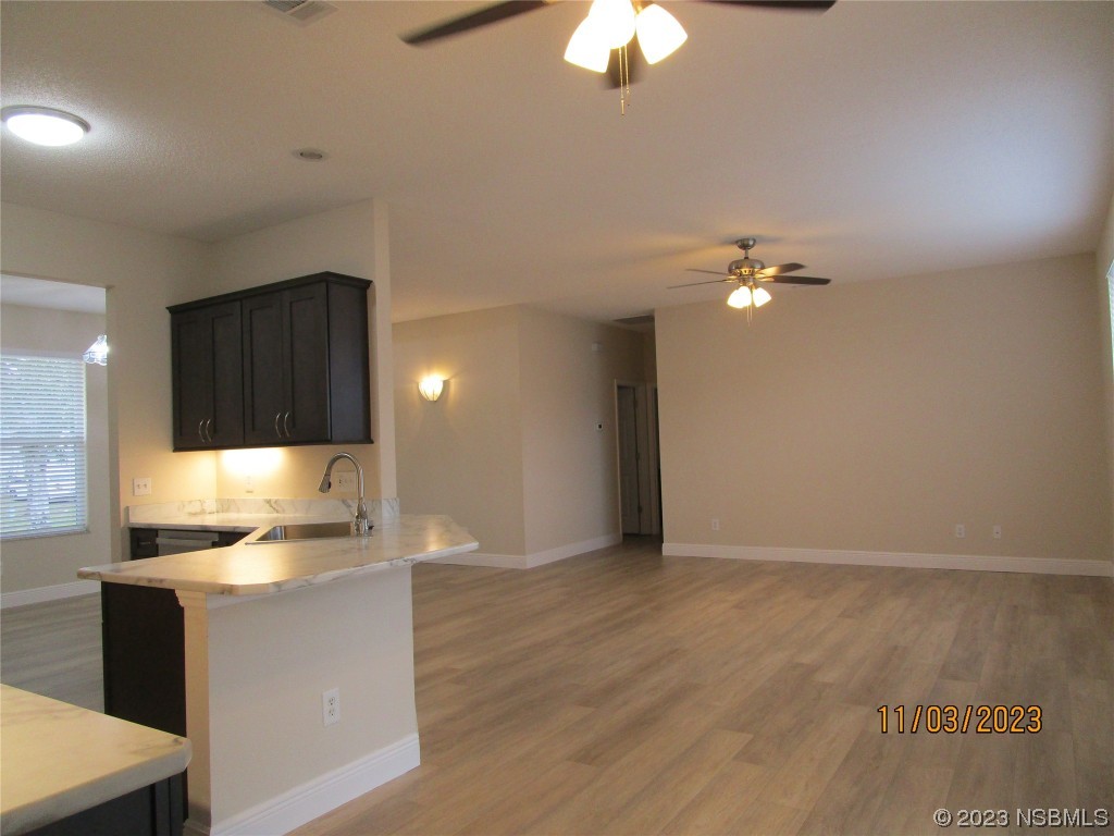 3117 Victory Palm Drive Edgewater, FL 32141 - Photo 5 of 23 a view of a kitchen with a sink cabinets and wooden floor