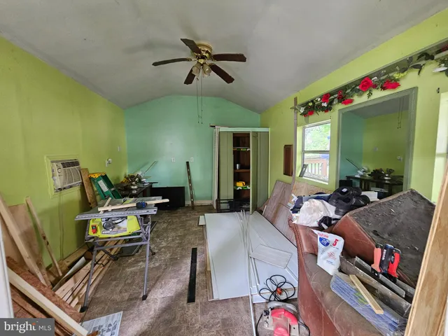 a front view of a house with a garden and trees