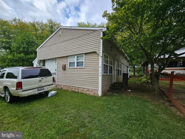 a view of a house with a backyard