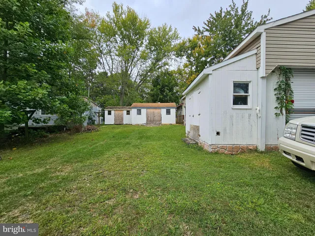 a front view of house with a garden