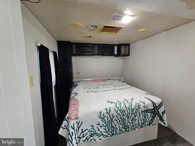 a view of a hallway with wooden walls and entryway