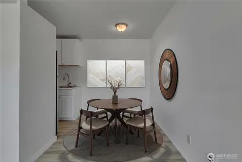 a dining room with furniture and a mirror