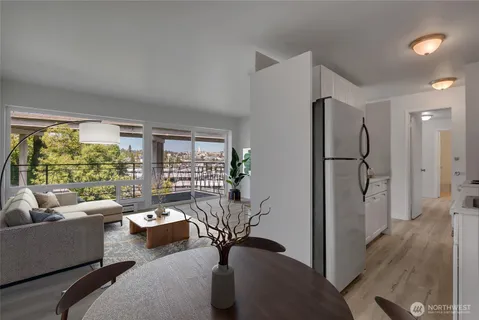 a living room with furniture and a floor to ceiling window