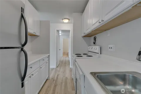 a kitchen with cabinets a sink and appliances