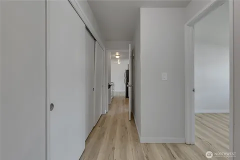 a view of a hallway with wooden floor