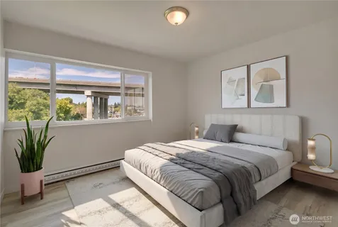 a bedroom with a large bed and a potted plant