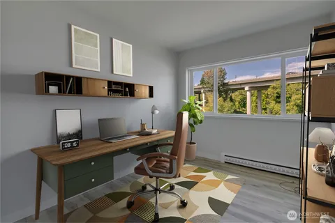 a view of a workspace with furniture and a window