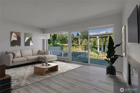 a living room with furniture floor to ceiling window and wooden floor