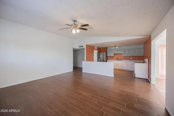 a view of a kitchen with wooden floor and a kitchen