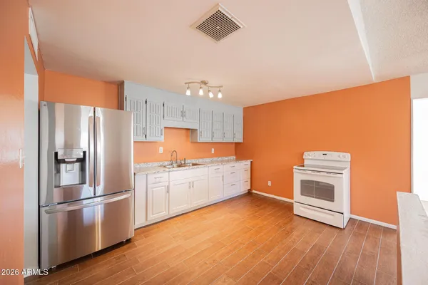 a kitchen with stainless steel appliances a refrigerator sink and microwave