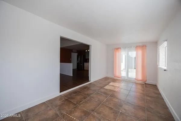 a view of a big room with windows and entryway