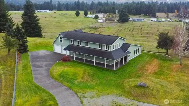 a view of a swimming pool with a yard and wooden fence
