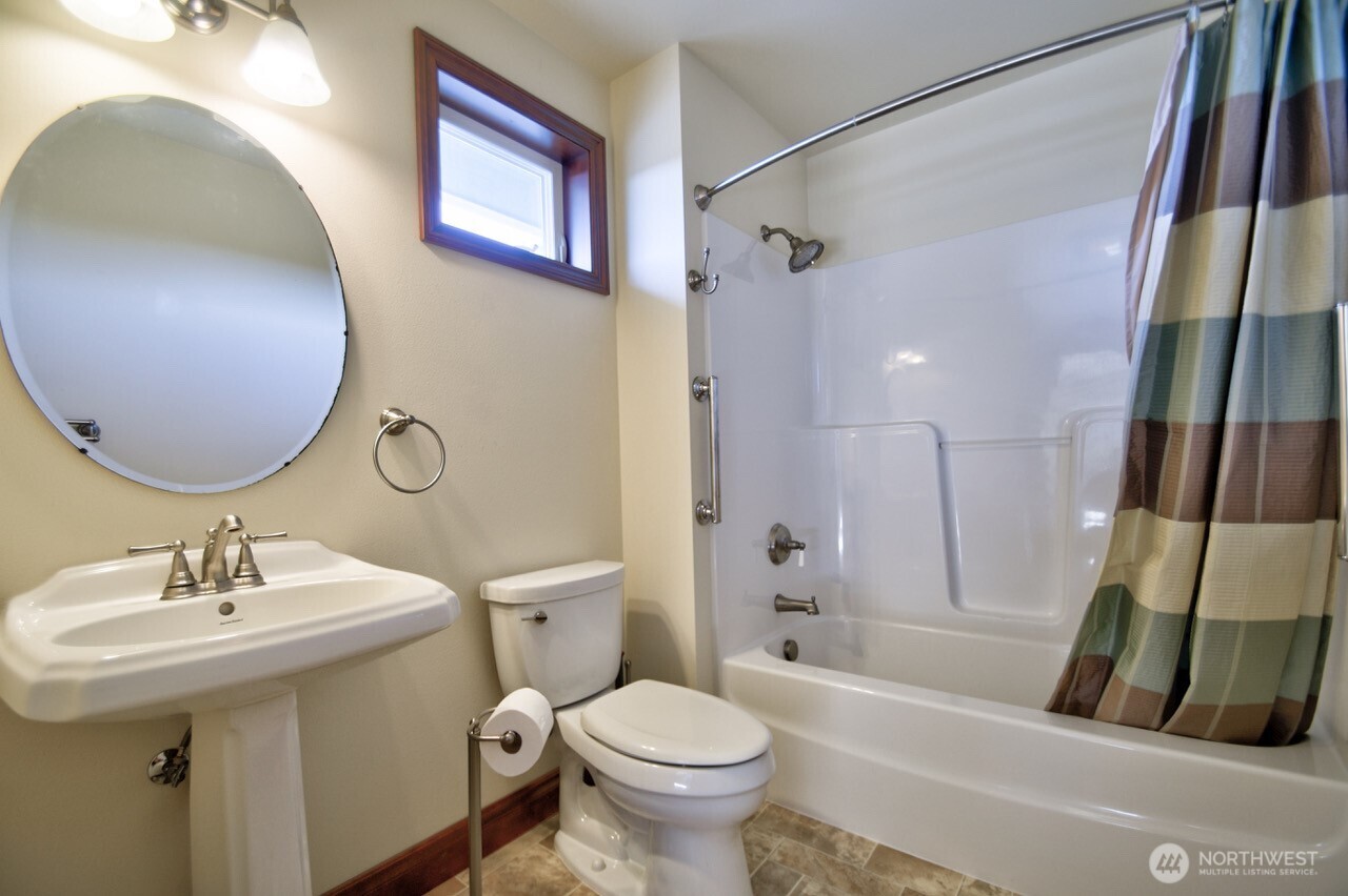 7737 Bordeaux Vista Road Southwest Olympia, WA 98512 - Photo 20 of 38 a bathroom with a sink toilet and shower