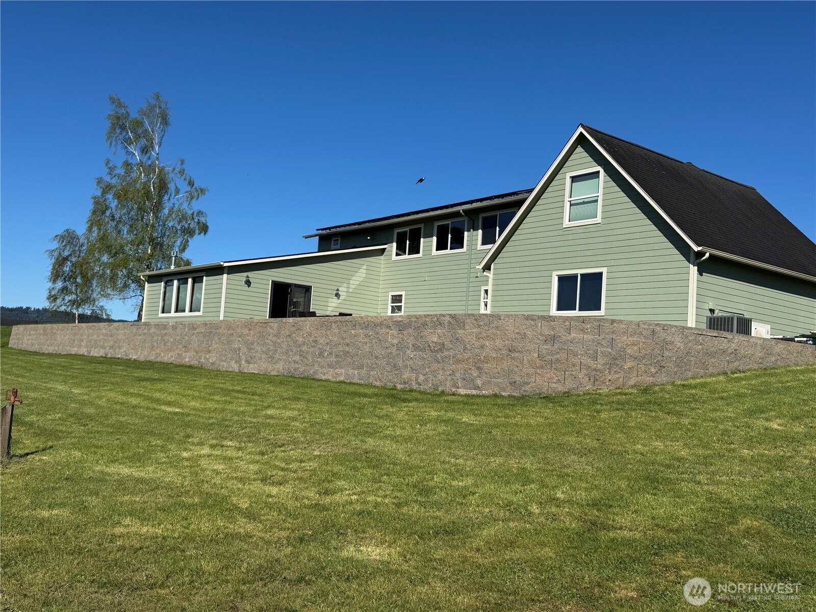 7737 Bordeaux Vista Road Southwest Olympia, WA 98512 - Photo 2 of 38 a front view of a house with a yard