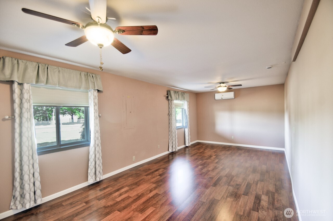 7737 Bordeaux Vista Road Southwest Olympia, WA 98512 - Photo 25 of 38 a view of an empty room with a window and wooden floor