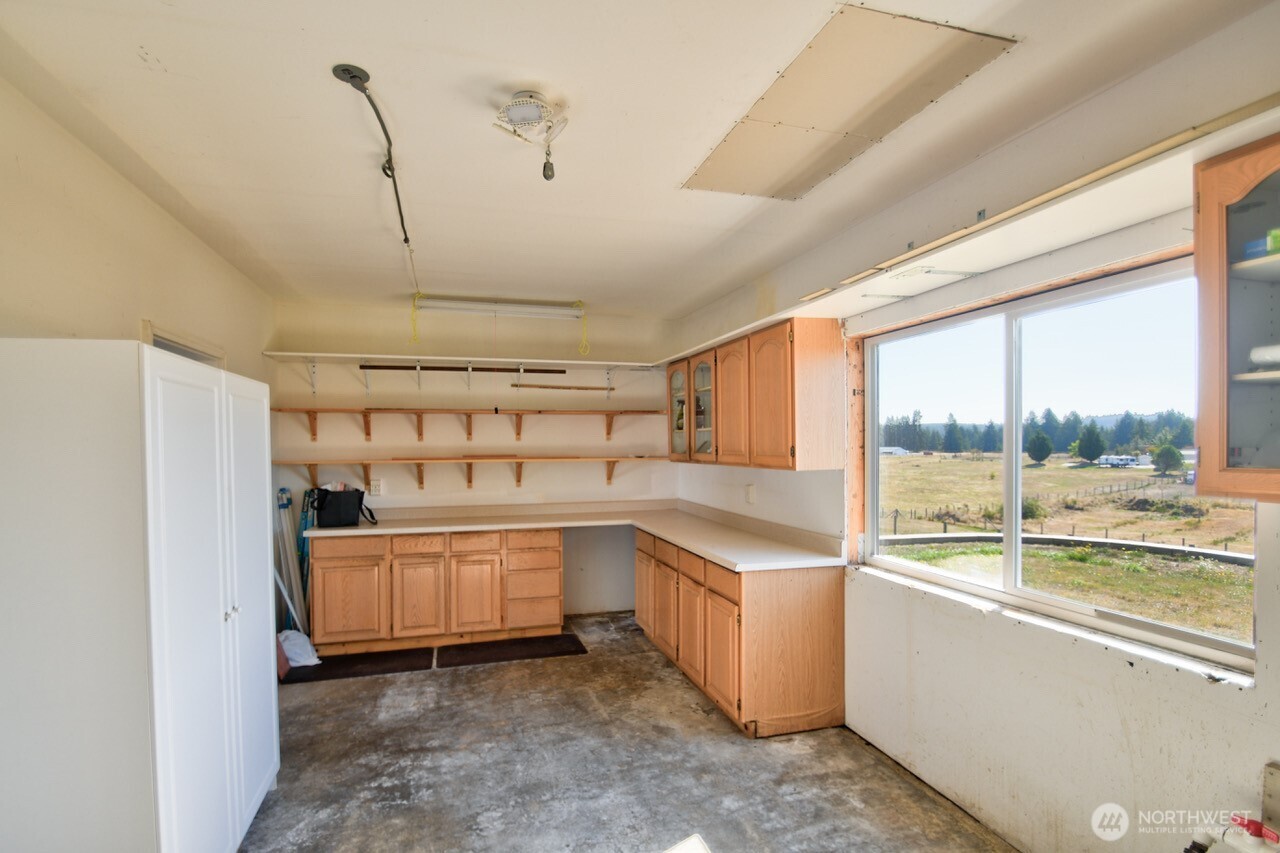 7737 Bordeaux Vista Road Southwest Olympia, WA 98512 - Photo 31 of 38 a kitchen with counter top space and appliances