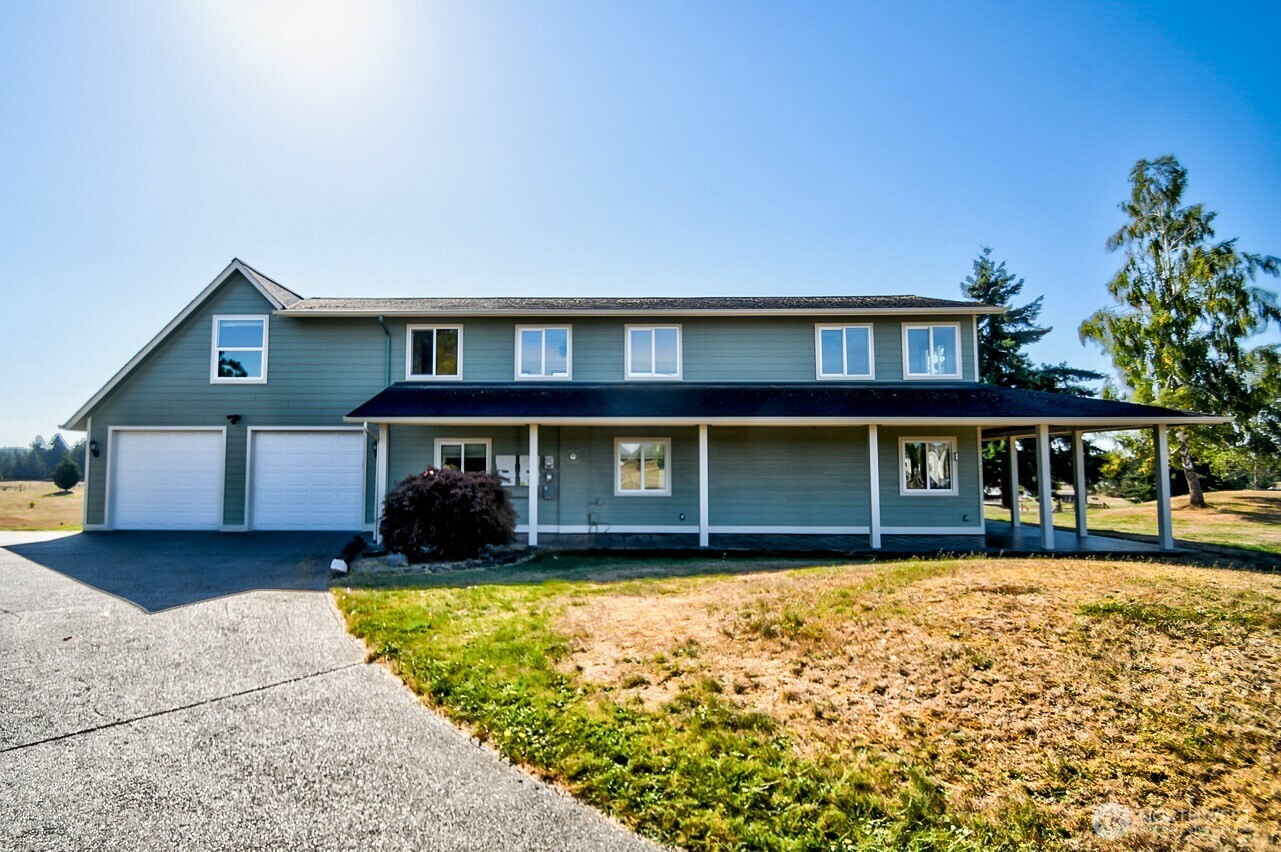 7737 Bordeaux Vista Road Southwest Olympia, WA 98512 - Photo 33 of 38 front view of a house with a yard