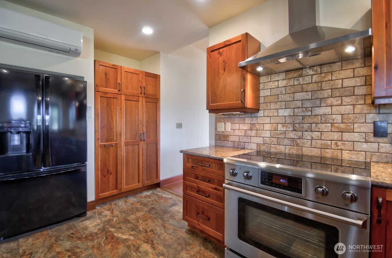 7737 Bordeaux Vista Road Southwest Olympia, WA 98512 - Photo 6 of 38 a kitchen with a stove and a refrigerator