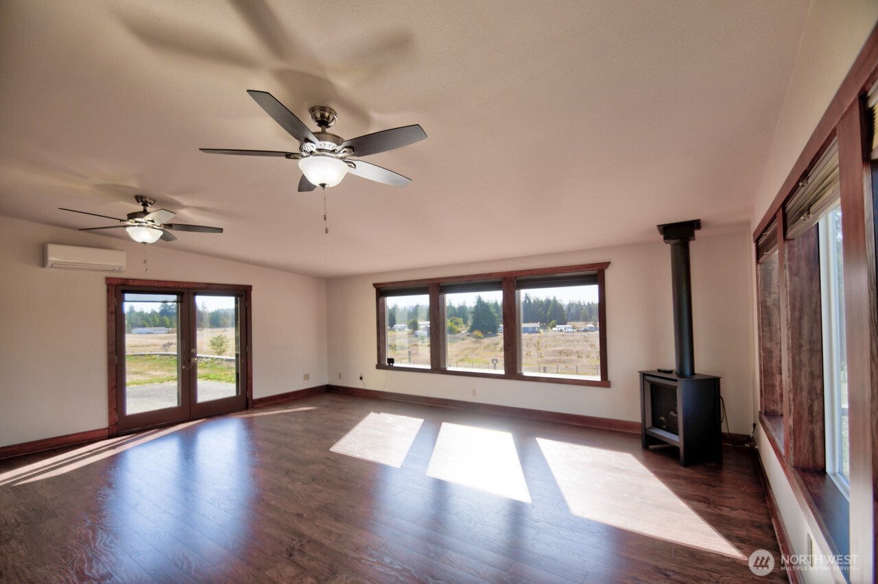 7737 Bordeaux Vista Road Southwest Olympia, WA 98512 - Photo 8 of 38 a view of an empty room with a window and wooden floor