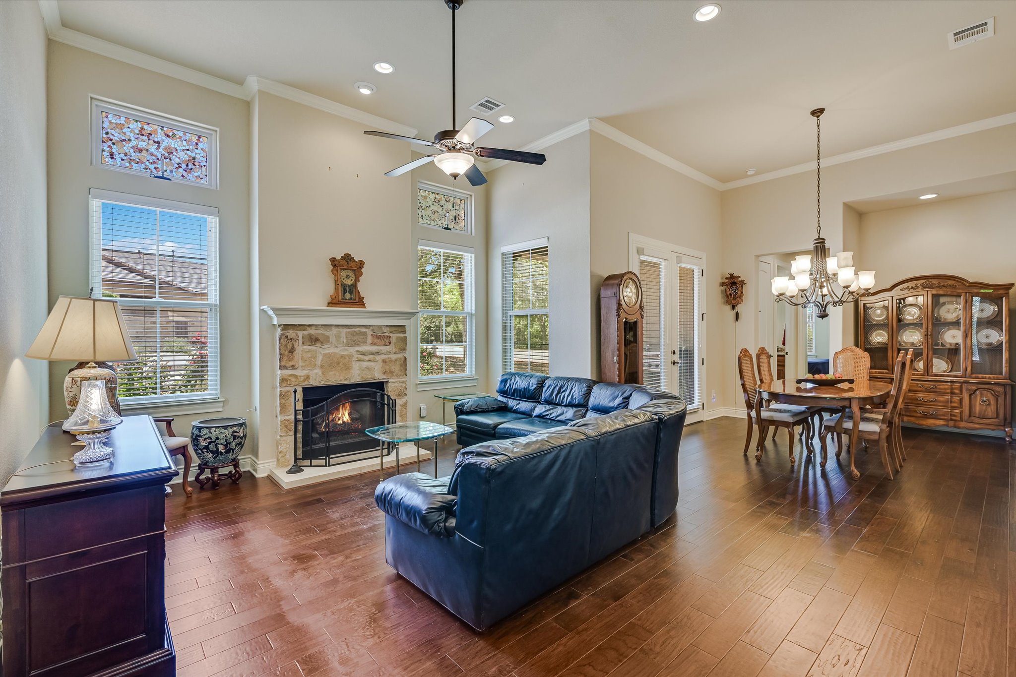 103 Rivalto Circle, Unit 1 Lakeway, TX 78734 - Photo 2 of 34 Living room with high ceilings, hardwood floors and a fireplace