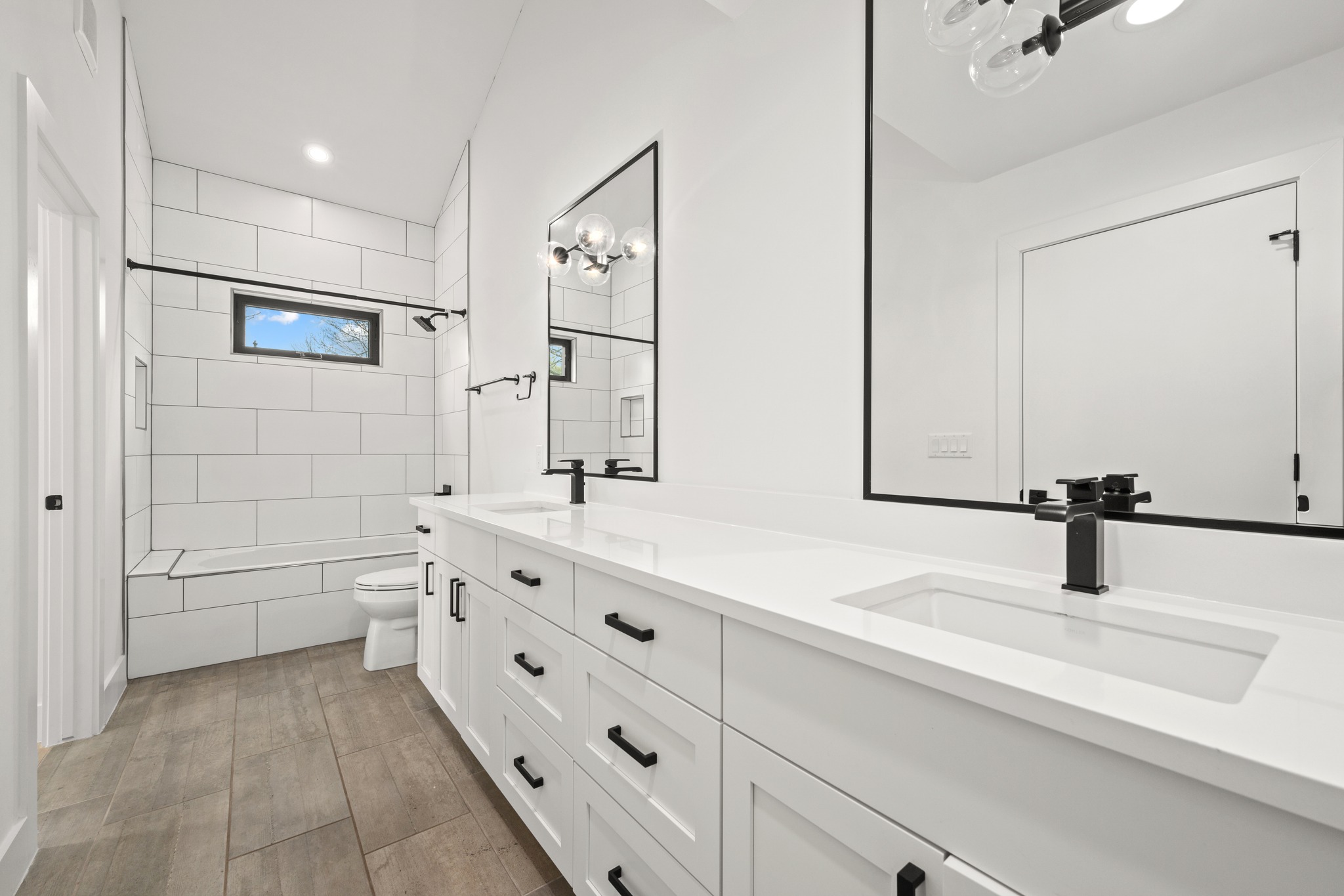 503 Havana Street, Unit A Austin, TX 78704 - Photo 18 of 28 Bathroom with double vanity, recessed lighting, light wood finished floors, and tiled shower / bath combo