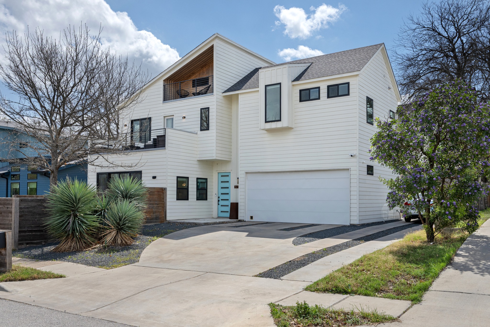 503 Havana Street, Unit A Austin, TX 78704 - Photo 2 of 28 Contemporary home with a balcony, an attached garage, and concrete driveway