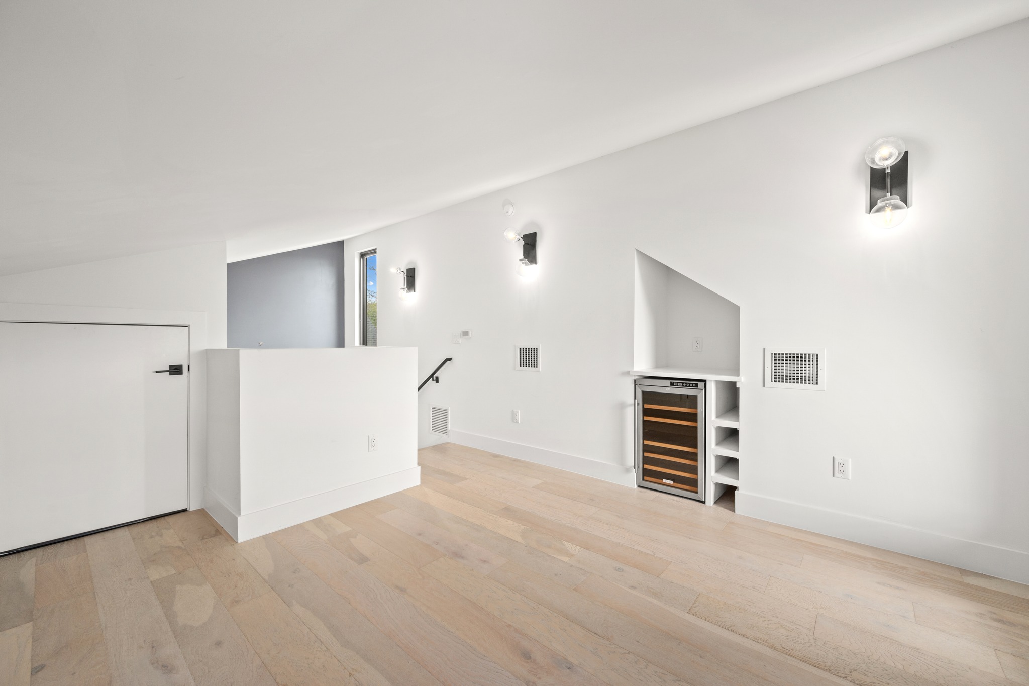 503 Havana Street, Unit A Austin, TX 78704 - Photo 20 of 28 Empty room with beverage cooler, lofted ceiling, and light wood-style floors