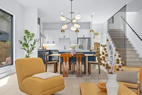 a dining room filled with furniture and wooden floor