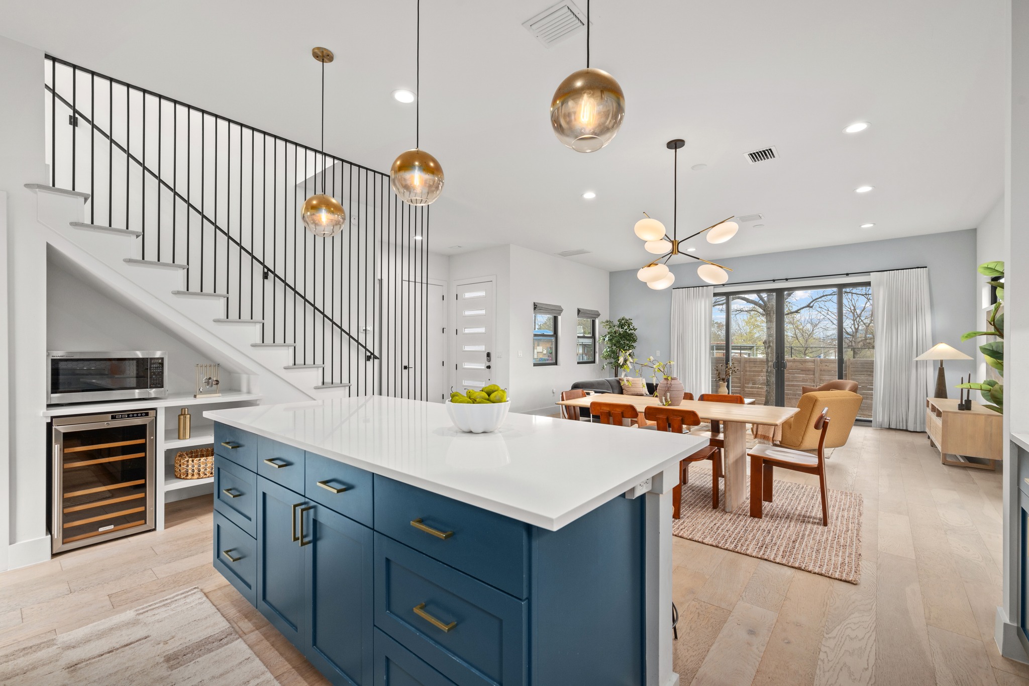 503 Havana Street, Unit A Austin, TX 78704 - Photo 28 of 28 Kitchen with blue cabinetry, wine cooler, open floor plan, a center island, and light wood-type flooring