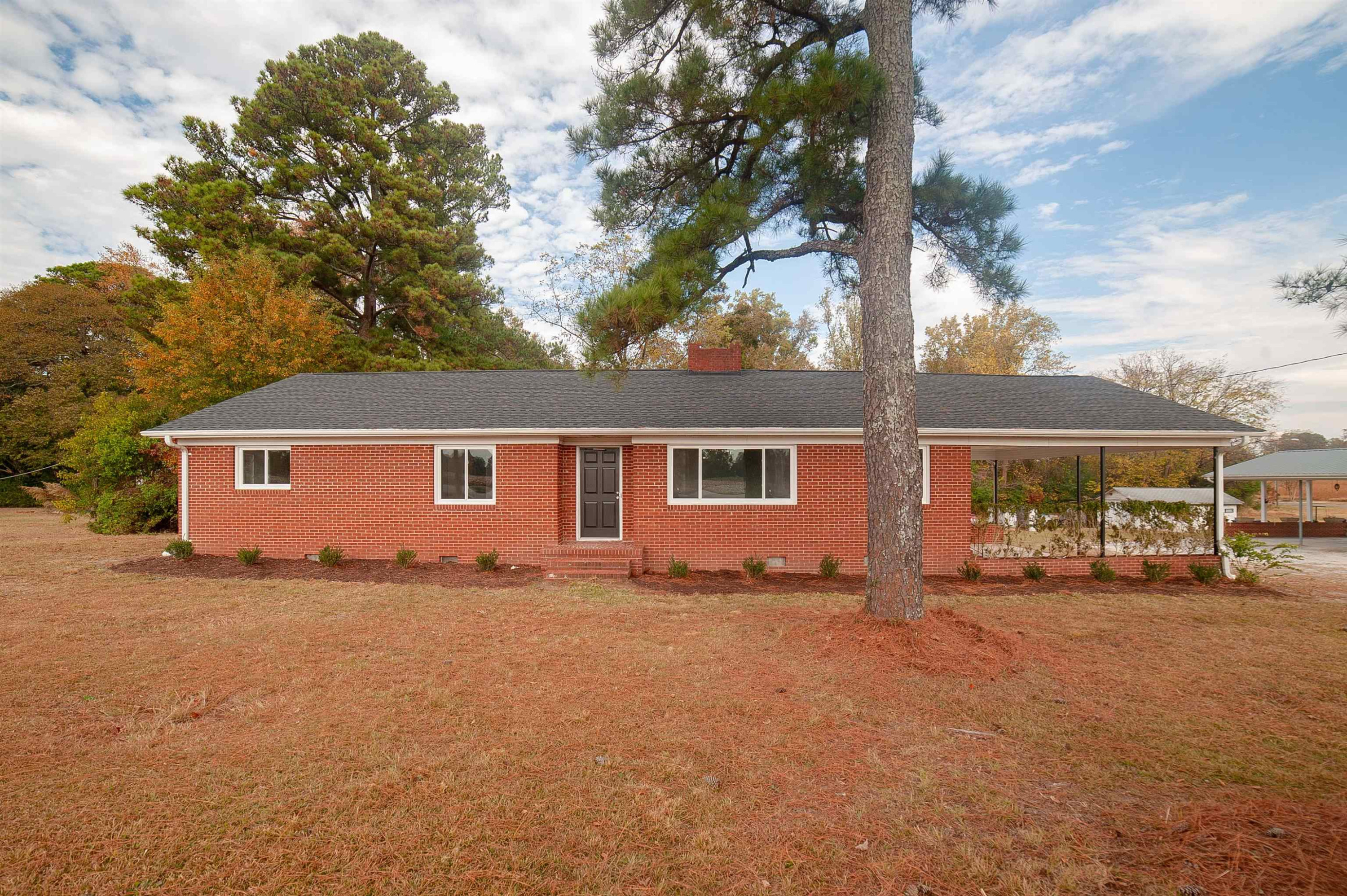 1206 Erwin Road Dunn, NC 28334 - Photo 1 of 24 front view of a house with a yard