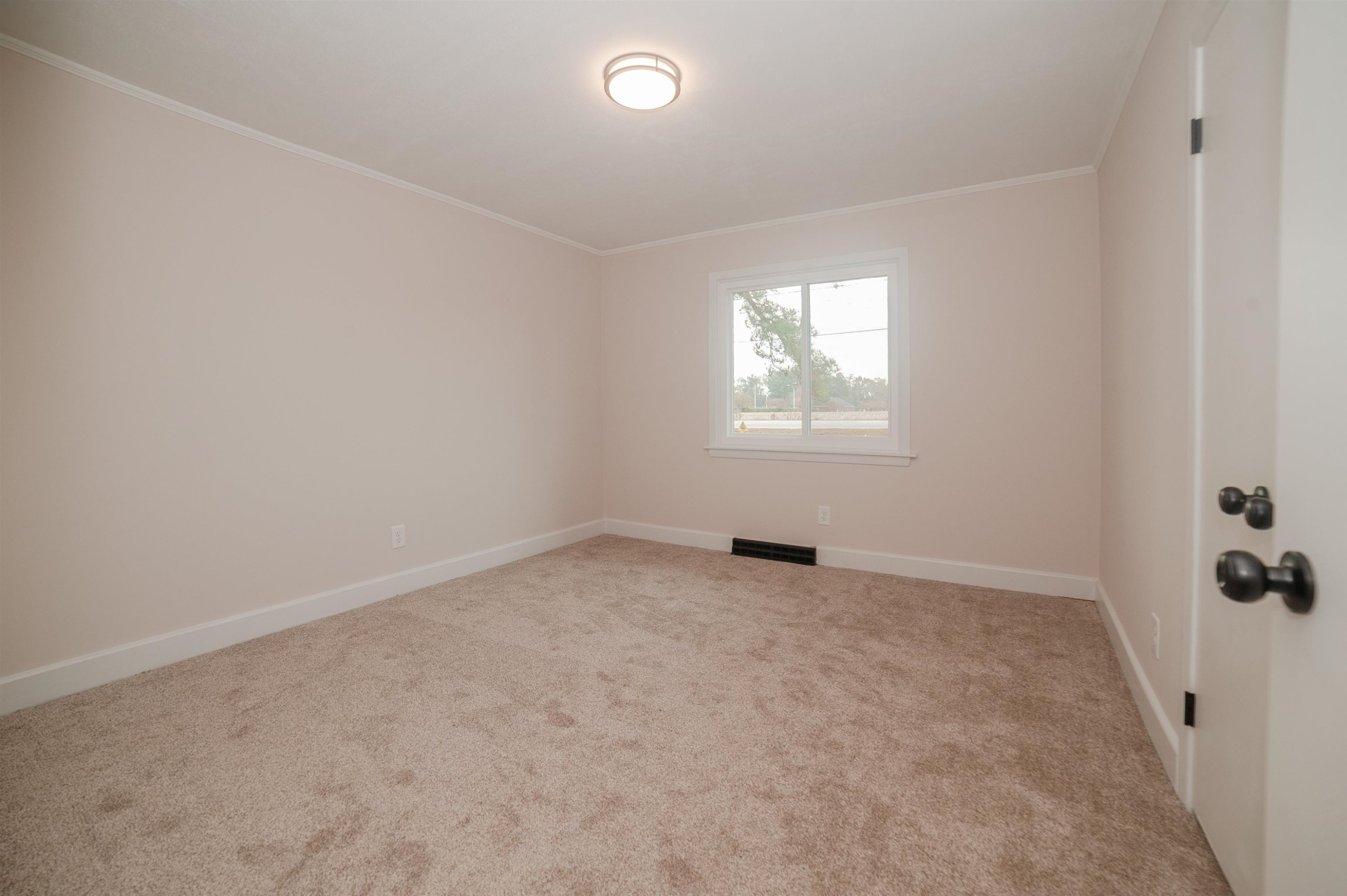 1206 Erwin Road Dunn, NC 28334 - Photo 13 of 24 an empty room with windows