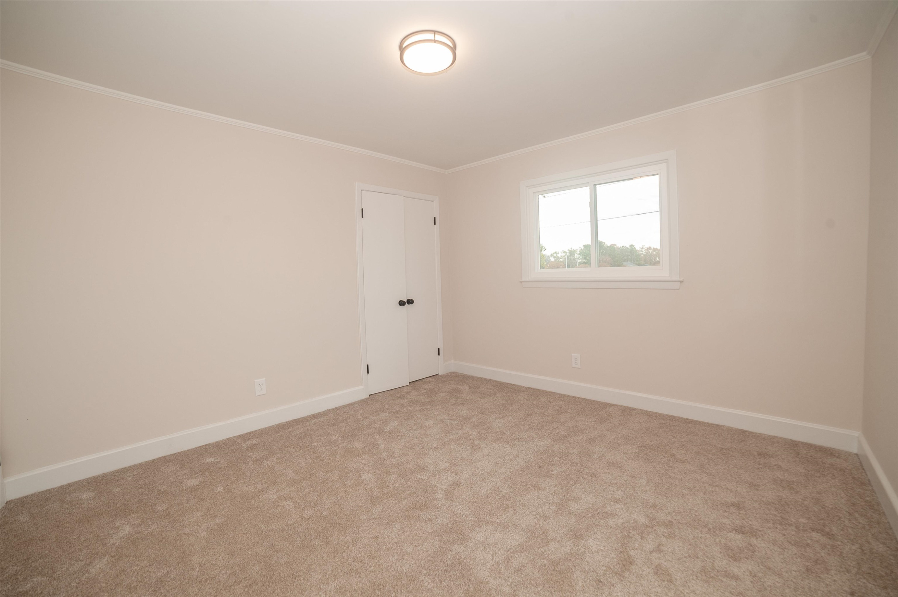1206 Erwin Road Dunn, NC 28334 - Photo 16 of 24 an empty room with a window