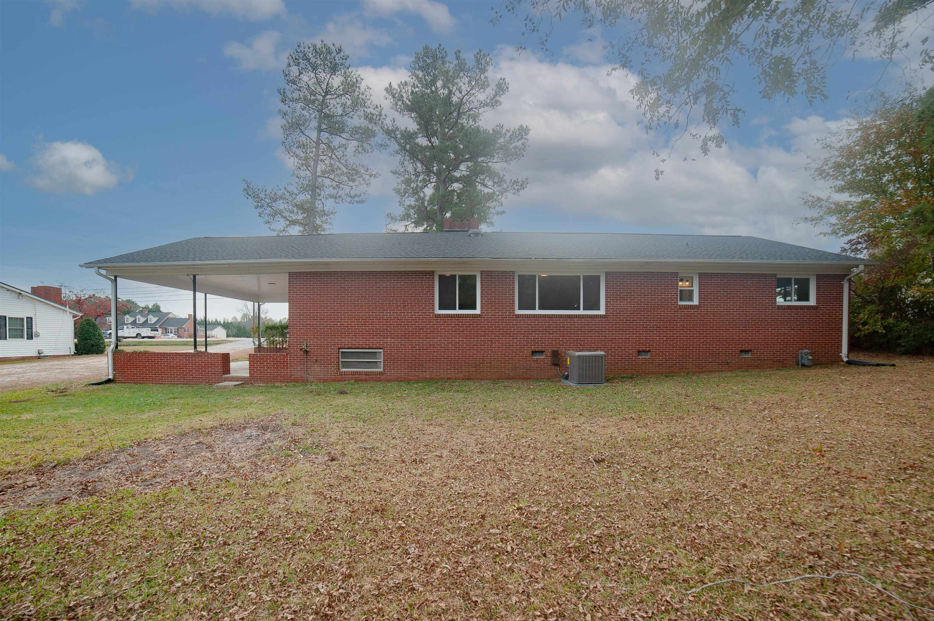 1206 Erwin Road Dunn, NC 28334 - Photo 2 of 24 a backyard of a house with table and chairs