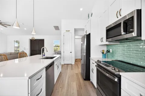 a large white kitchen with lots of counter space