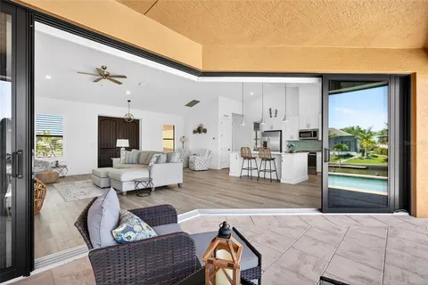 a living room with furniture and a floor to ceiling window