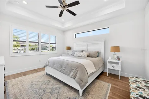 a bedroom with a large bed and a chandelier