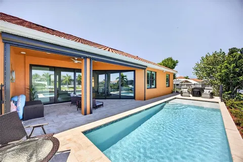 a view of a house with a yard and deck