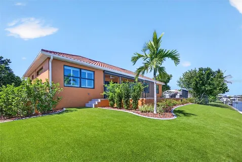 a swimming pool with outdoor seating and yard