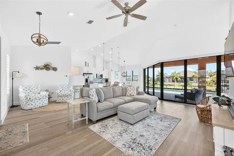 a living room with furniture and kitchen view