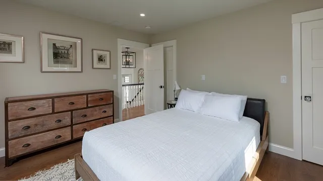 a large bed sitting in a bedroom and dresser