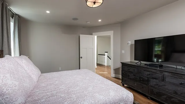 a bedroom with a bed and a flat screen tv