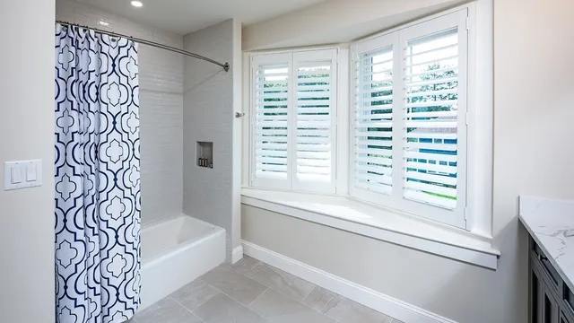 a bathroom with bathtub and window