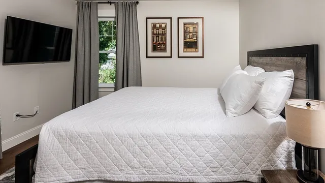 a bedroom with a bed and a flat screen tv