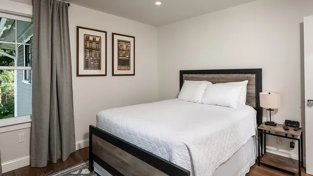 a bedroom with a bed and a window