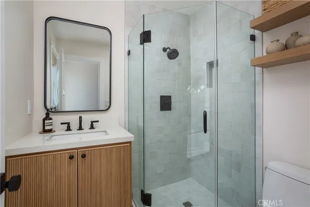 a bathroom with a double vanity sink mirror and shower
