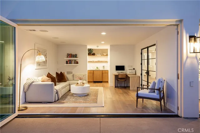 a living room with fireplace furniture and a potted plant