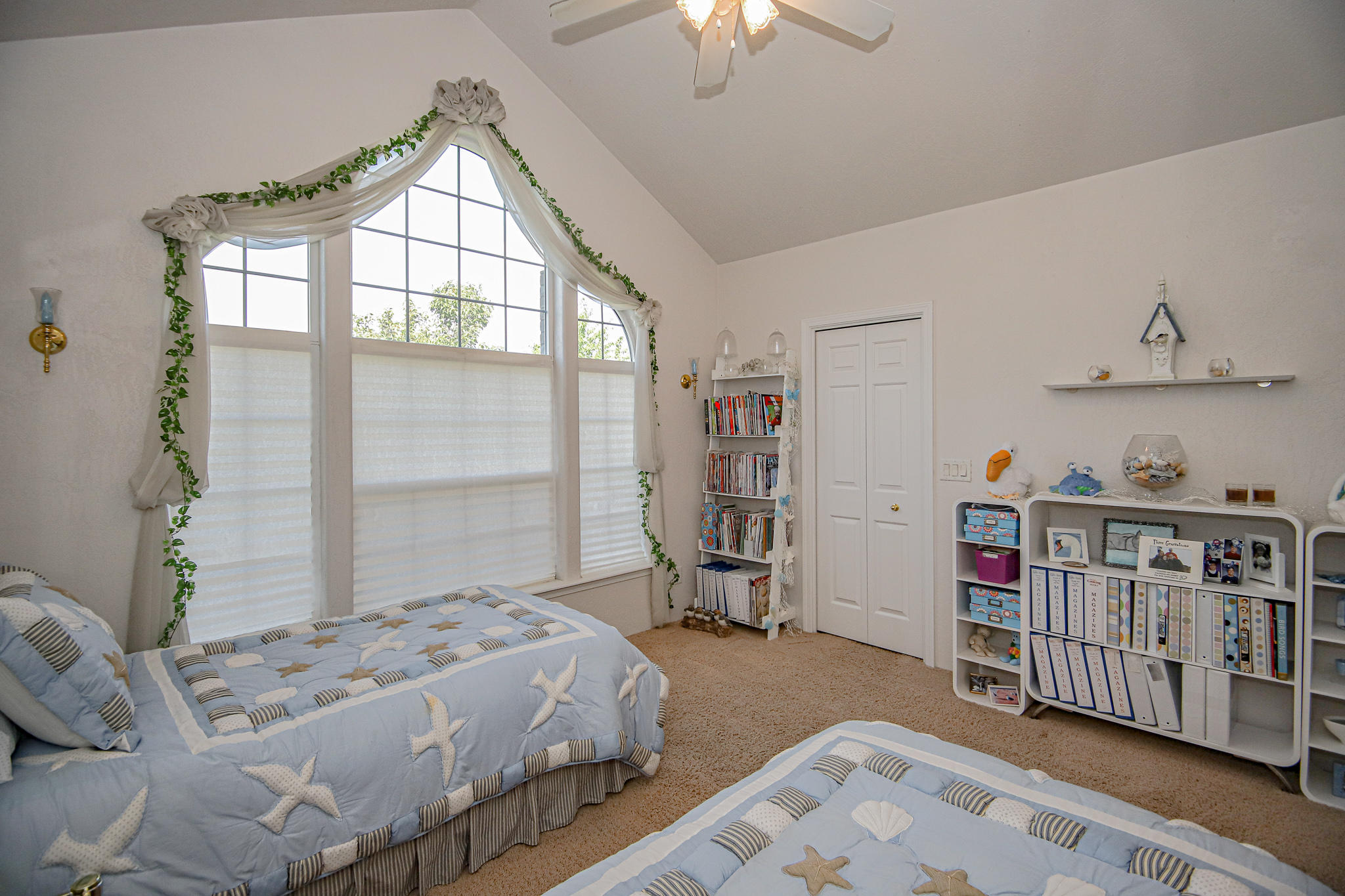 2876 Beebe Road Central Point, OR 97502 - Photo 20 of 34 a bedroom with a bed a bookshelf and a window